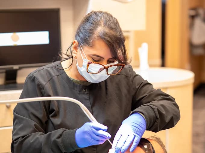 Dental hygienist treating a patient at All Smiles Dental Care in Calgary
