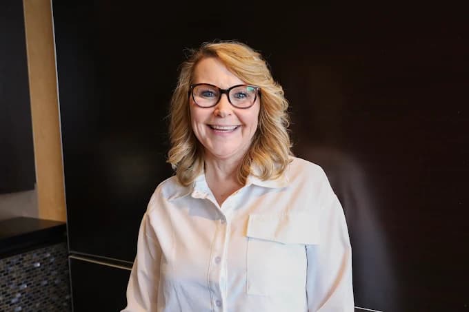 Smiling All Smiles Dental Care team member welcoming patients in Calgary